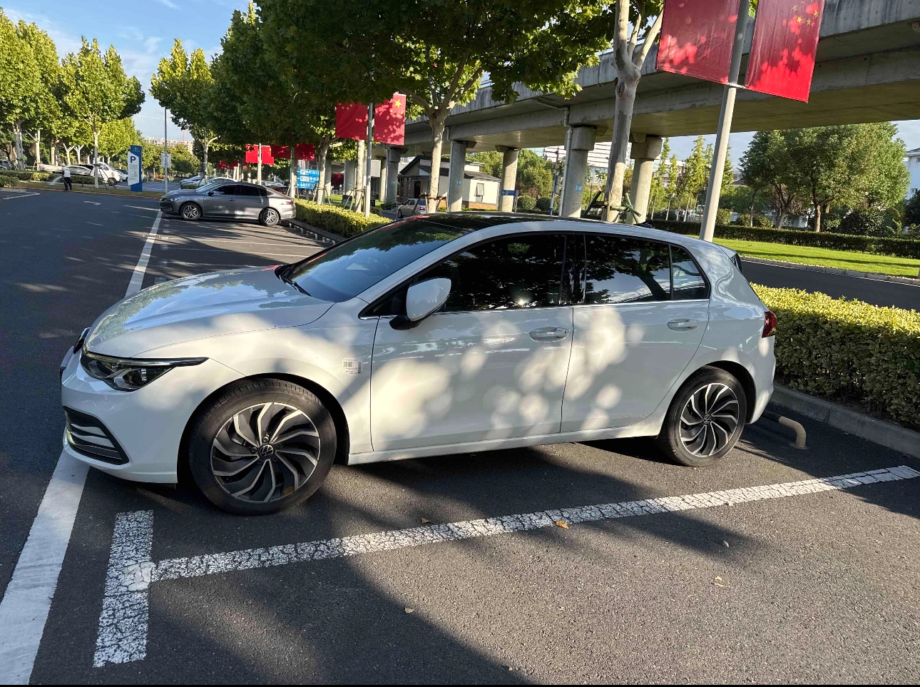 white-volkswagen-golf-parked-in-parking-lot